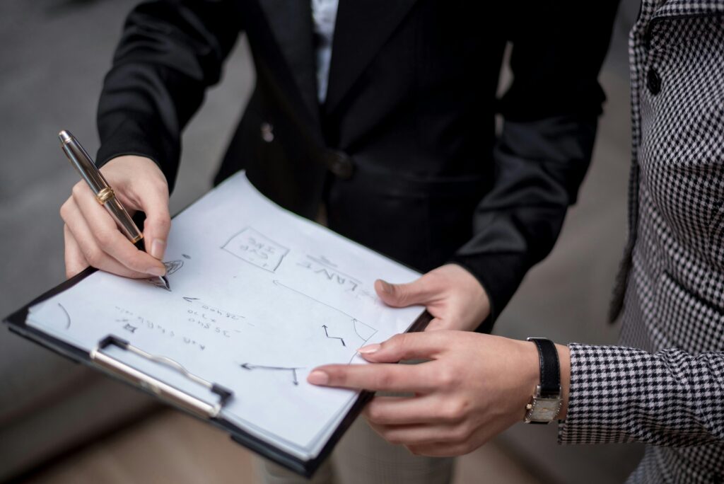 A Person in Black Suit Writing in the Paper